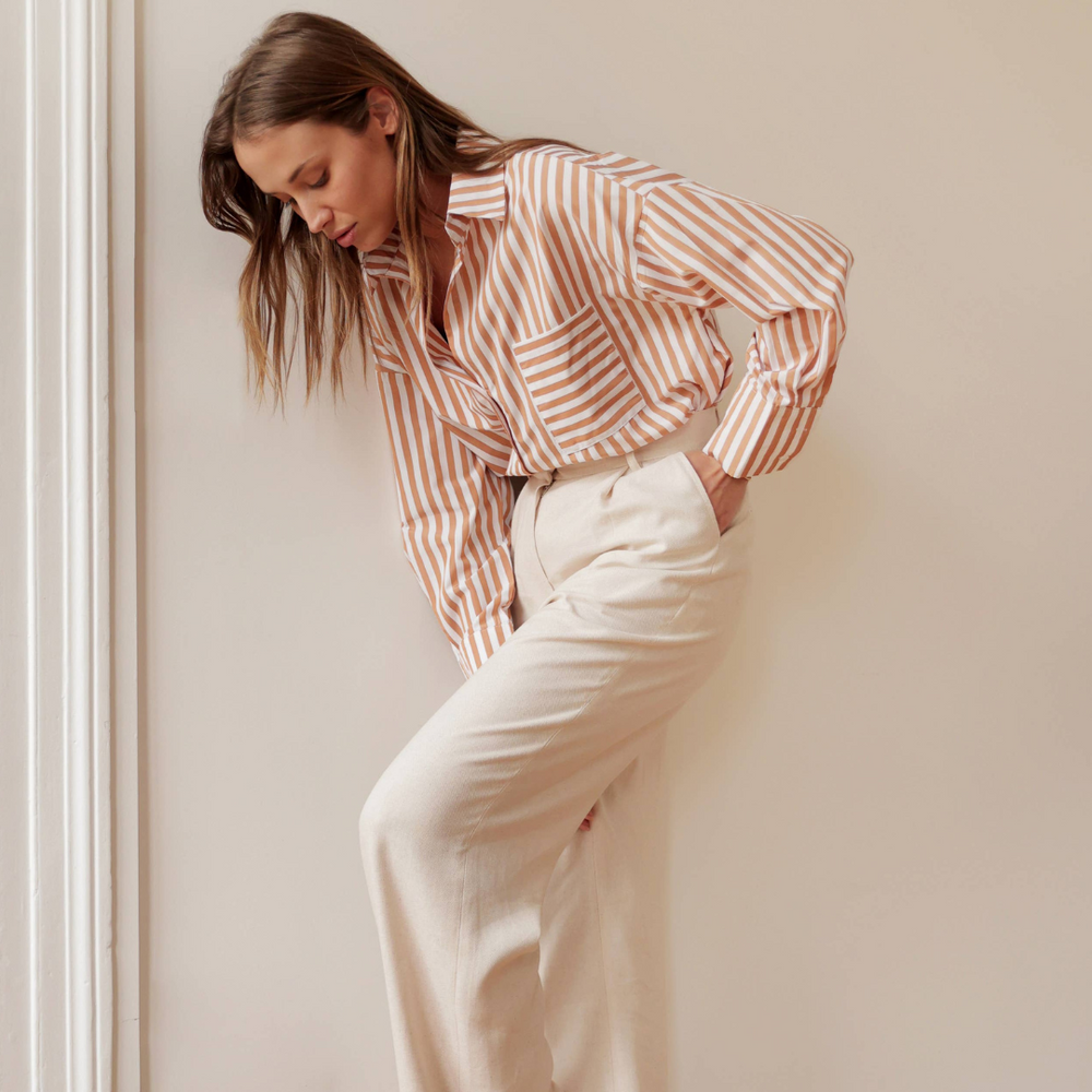 
                      
                        Oversized Celia Striped Shirt in camel with modern mixed stripes, perfect button-down for versatile casual or date night wear
                      
                    