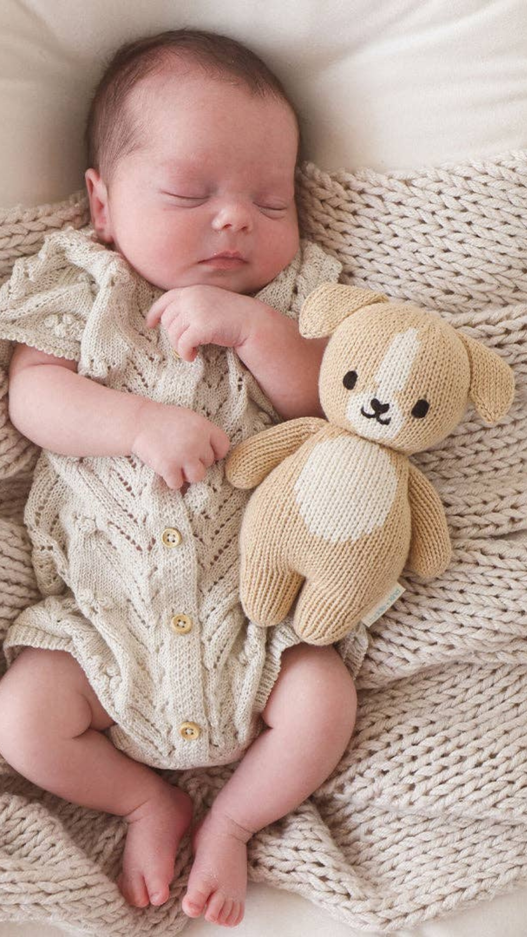 Happy child cuddling the Baby Puppy doll, showing off its perfect size for little hands and its cuddly, soft texture.