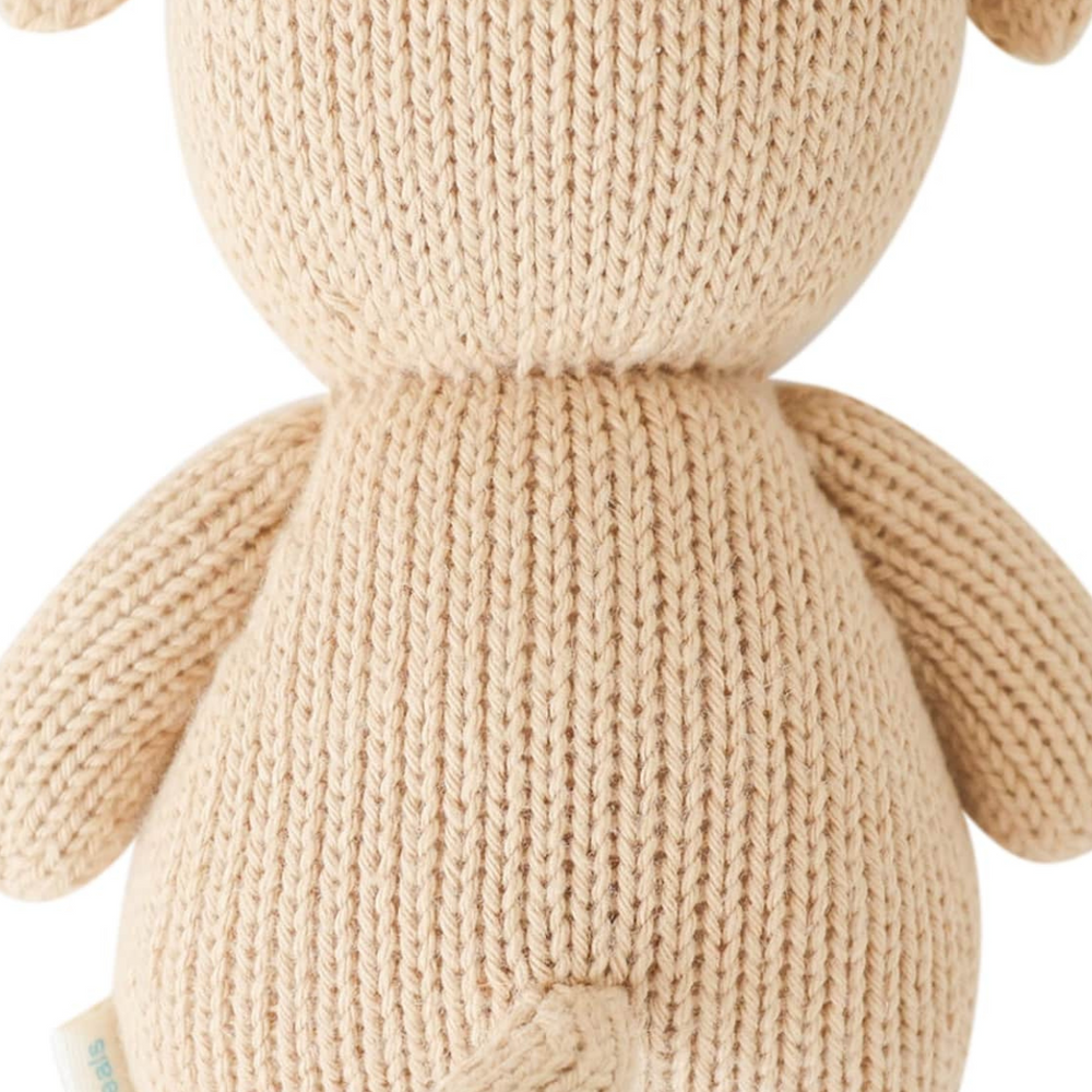 
                      
                        Back view of the Cuddle + Kind Baby Puppy, showcasing its high-quality hand-knit design, premium cotton yarn, and adorable details from the back, perfect for collectors and little ones alike.
                      
                    