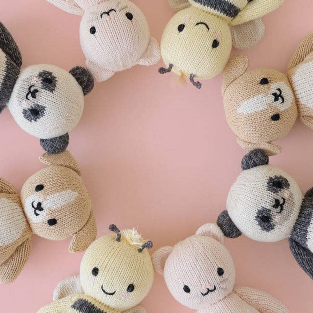 
                      
                        Circular flat lay of Cuddle + Kind baby animals, featuring the Baby Puppy alongside other collectible baby animals, each hand-knitted with care using natural cotton yarn.
                      
                    