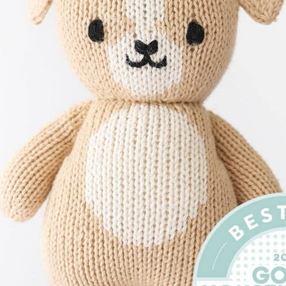 
                      
                        The Baby Puppy in the palm of a hand, with the Good Housekeeping Best Toy Award seal prominently displayed, emphasizing its recognition as a top toy for children.
                      
                    