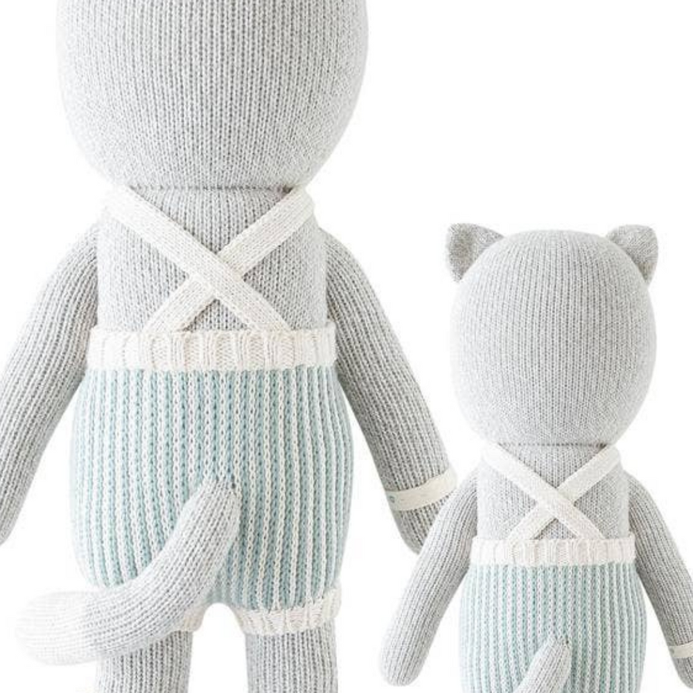 
                      
                        Back view of both sizes of Dylan the Kitten, highlighting the durability and soft texture of the hand-knit doll.
                      
                    