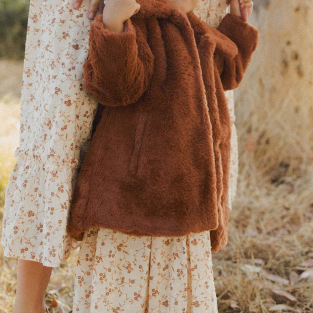 
                      
                        Child wearing Eloise Coat in Copper with mom during family photo session, a stylish choice for seasonal photos and holiday gatherings.
                      
                    