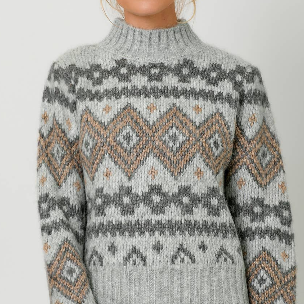 
                      
                        Close-up of the Fair Isle Mock Neck Sweater’s luxurious lurex detailing, capturing the shimmer and texture
                      
                    