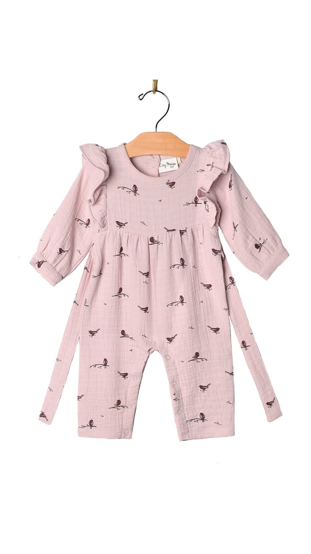 Flat lay of the Flutter Sleeve Long Romper in Fall Lavender Birds print by City Mouse, featuring soft muslin fabric, flutter sleeves, and a back tie detail, styled with delicate lavender floral accents.