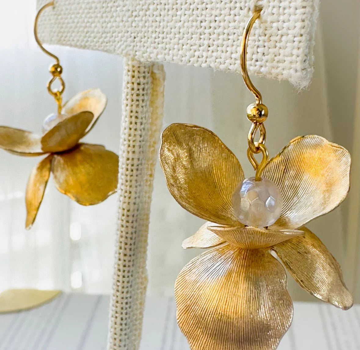 Golden Petals No. 10 Earrings by Carson & Co hanging, showing layered floral petal design.