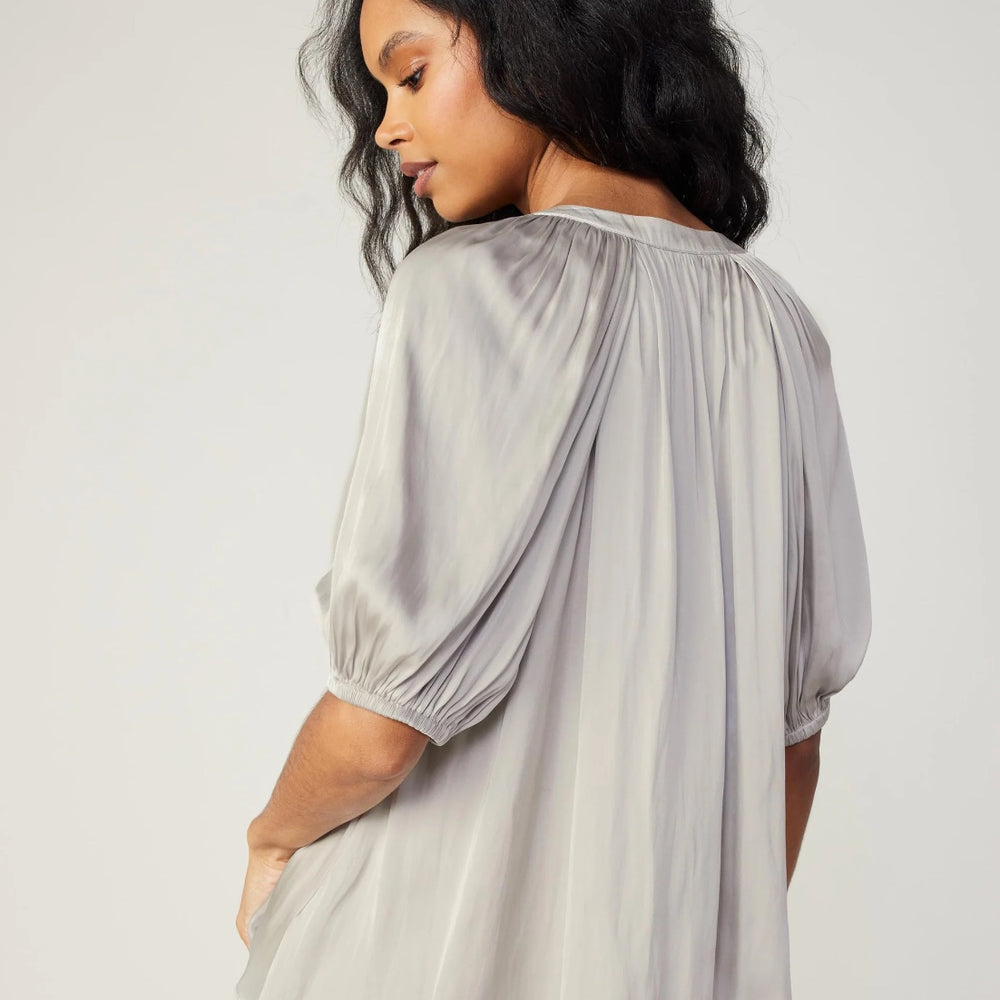 
                      
                        Back view of Hallie Half-Sleeve V-Neck Blouse in silver, showcasing eco-friendly 50% recycled polyester fabric
                      
                    