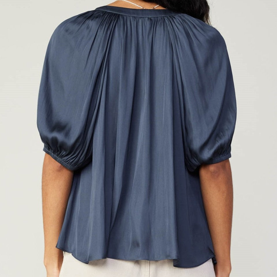 
                      
                        Back view of Half-Sleeve V-Neck Blouse in rich slate navy, showcasing the sleek design and eco-friendly recycled polyester blend
                      
                    