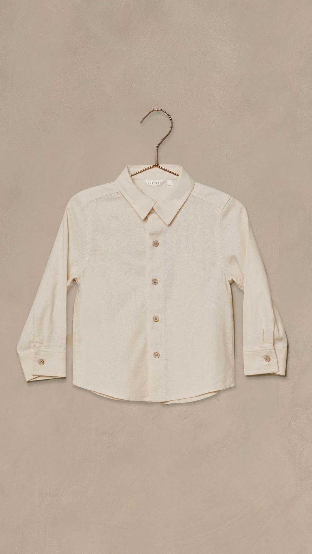 Close-up of button-front closure on boys linen blend shirt