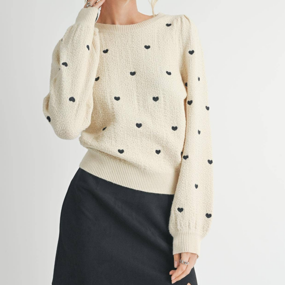 
                      
                        Heart Eyes Sweater in Natural Light: The soft cream sweater displayed in natural light to highlight its texture and color.
                      
                    