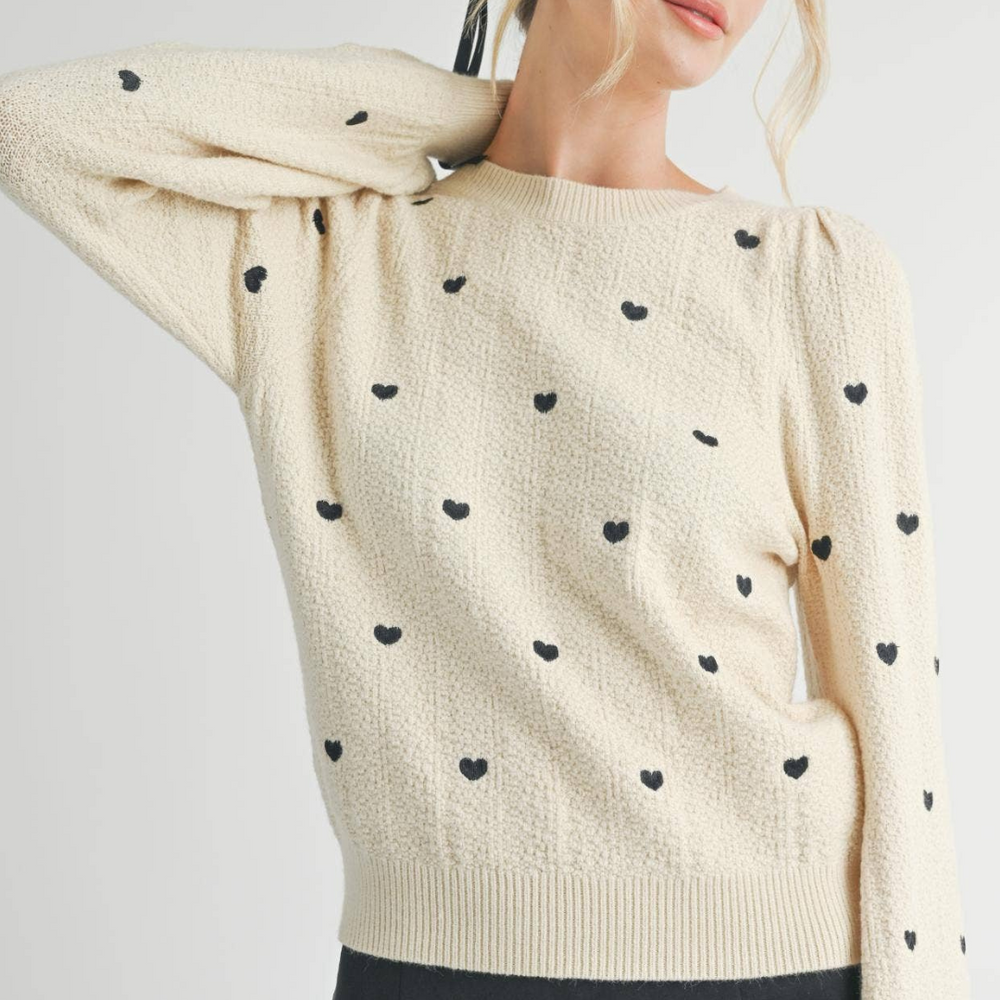 
                      
                        Heart Eyes Embroidered Sweater in Soft Cream: A cozy sweater featuring playful heart eyes embroidery, perfect for casual outings.
                      
                    