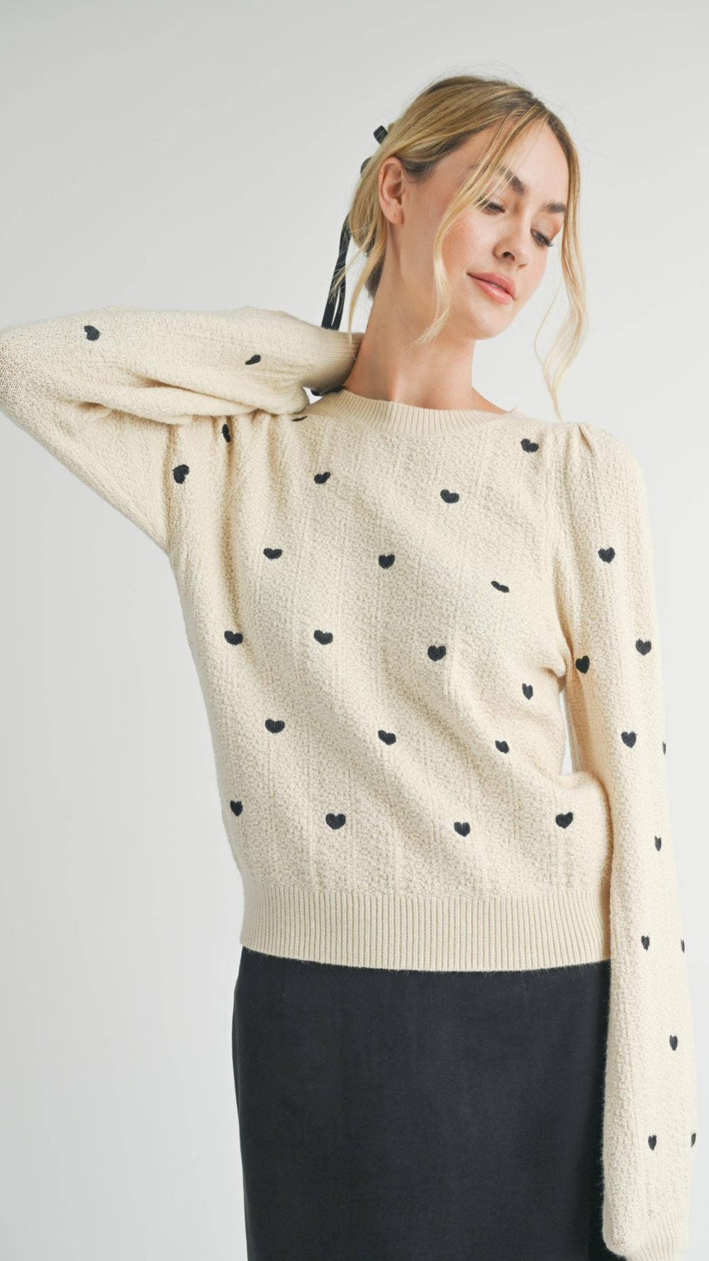 Heart Eyes Embroidered Sweater in Soft Cream: A cozy sweater featuring playful heart eyes embroidery, perfect for casual outings.