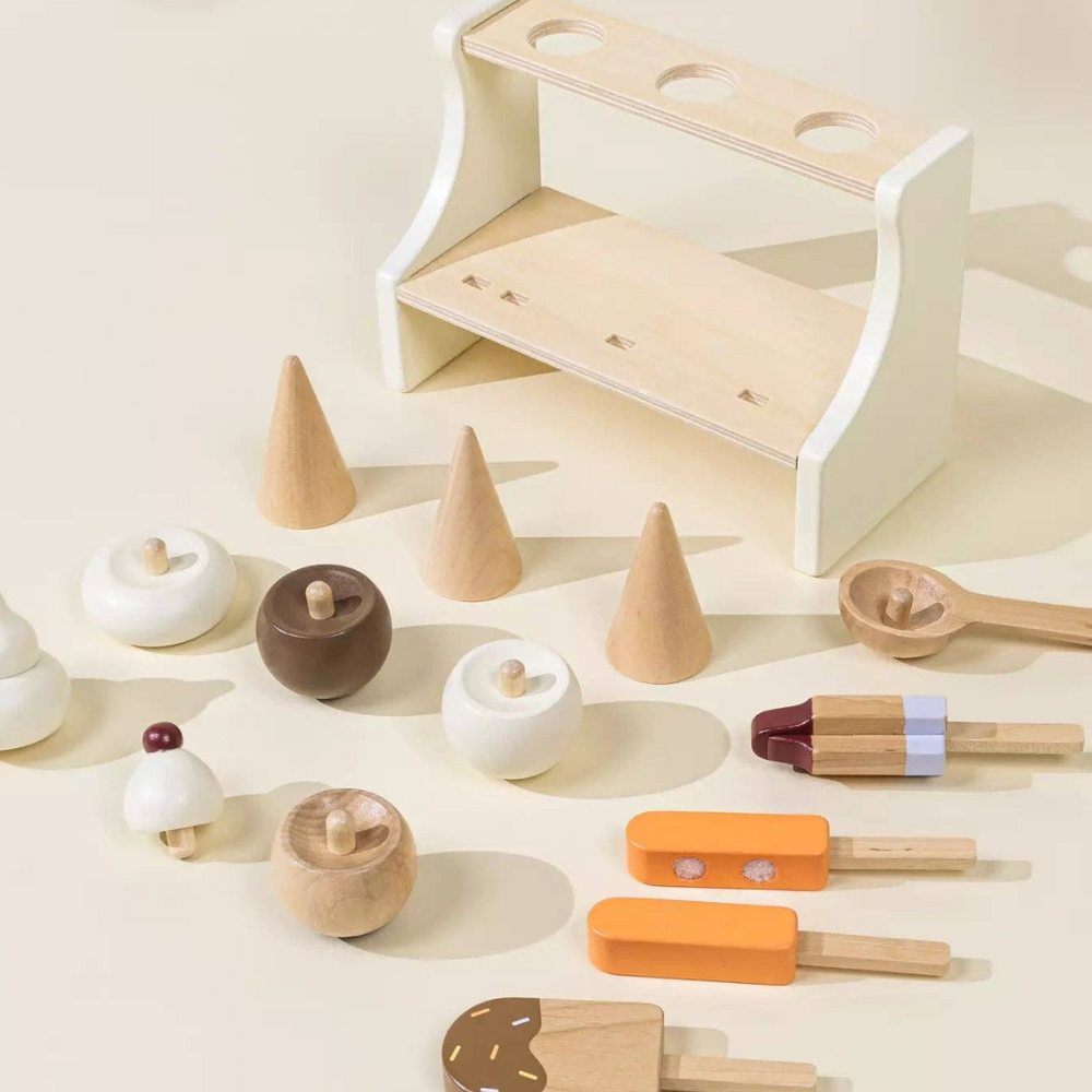 
                      
                        Complete display of Wooden Ice Cream Stand playset with three ice cream cones, three ice pops, and a spoon laid out, encouraging children to engage in creative, hands-on play while developing essential skills.
                      
                    