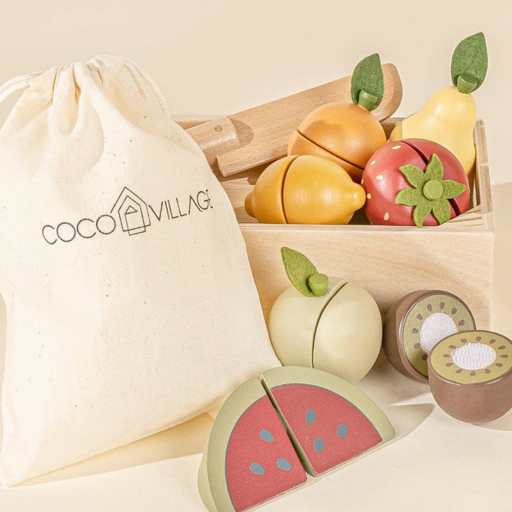 Close-up of wooden sliceable fruits like apple and lemon, with a wooden knife and storage bag, perfect for kids to practice their slicing skills and engage in pretend play markets or kitchens.