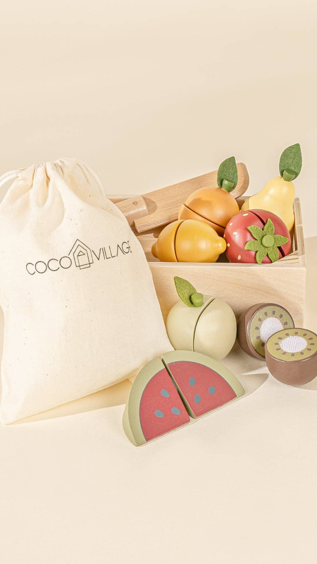 Close-up of wooden sliceable fruits like apple and lemon, with a wooden knife and storage bag, perfect for kids to practice their slicing skills and engage in pretend play markets or kitchens.