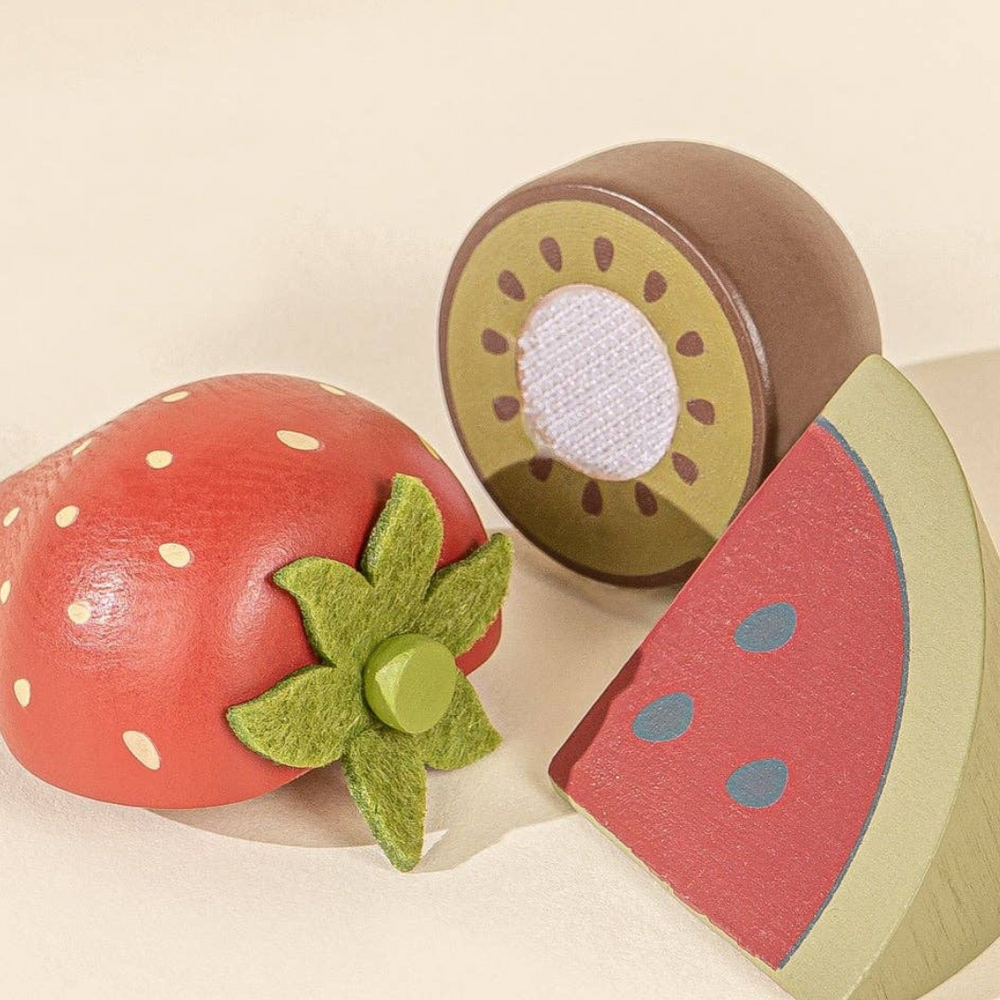 
                      
                        Close-up of colorful wooden fruits, including strawberry, kiwi, and watermelon, from the Wooden Fruits Playset, designed for imaginative play and enhancing fine motor skills in toddlers aged 3 and up.
                      
                    