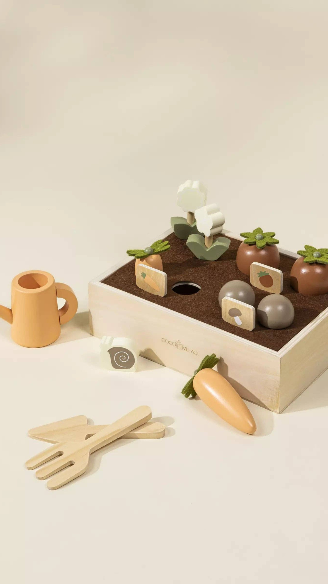 Wooden Gardening Playset displayed with vegetables like carrots and tomatoes ready to be "picked," alongside gardening tools and a watering can, encouraging imaginative nature play and skill development.