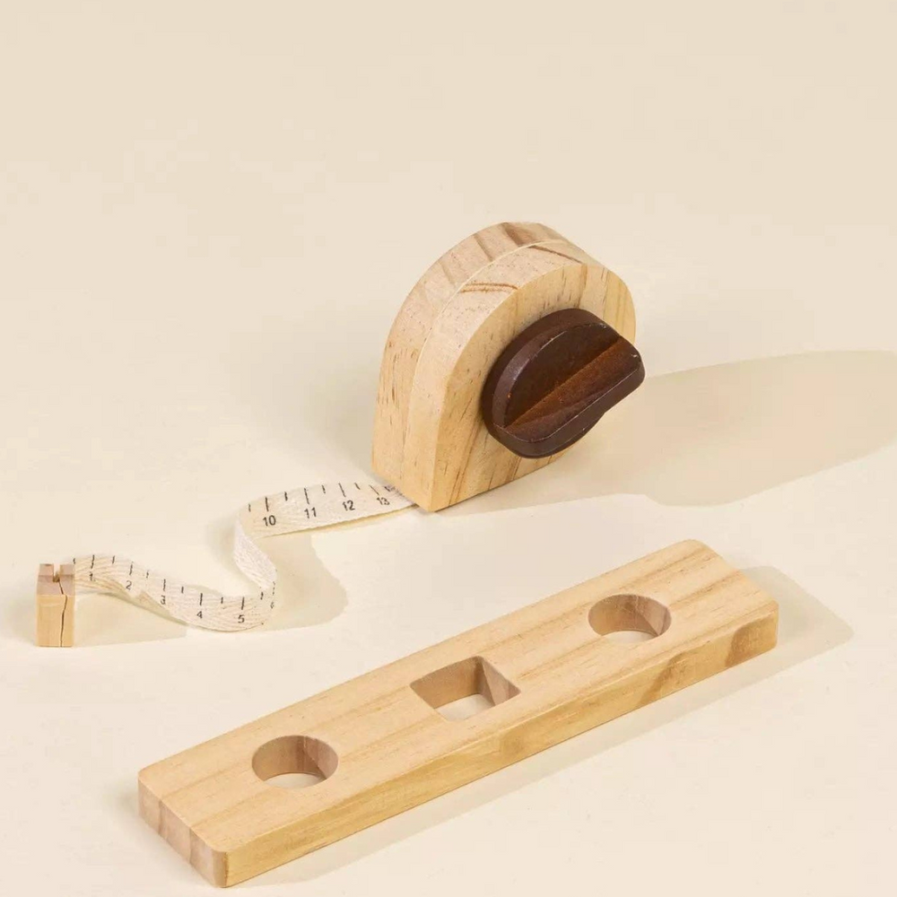 
                      
                        Close-up of level and tape measure from the Wooden Tool Playset, perfect for little builders to develop measurement skills and engage in imaginative construction projects.
                      
                    