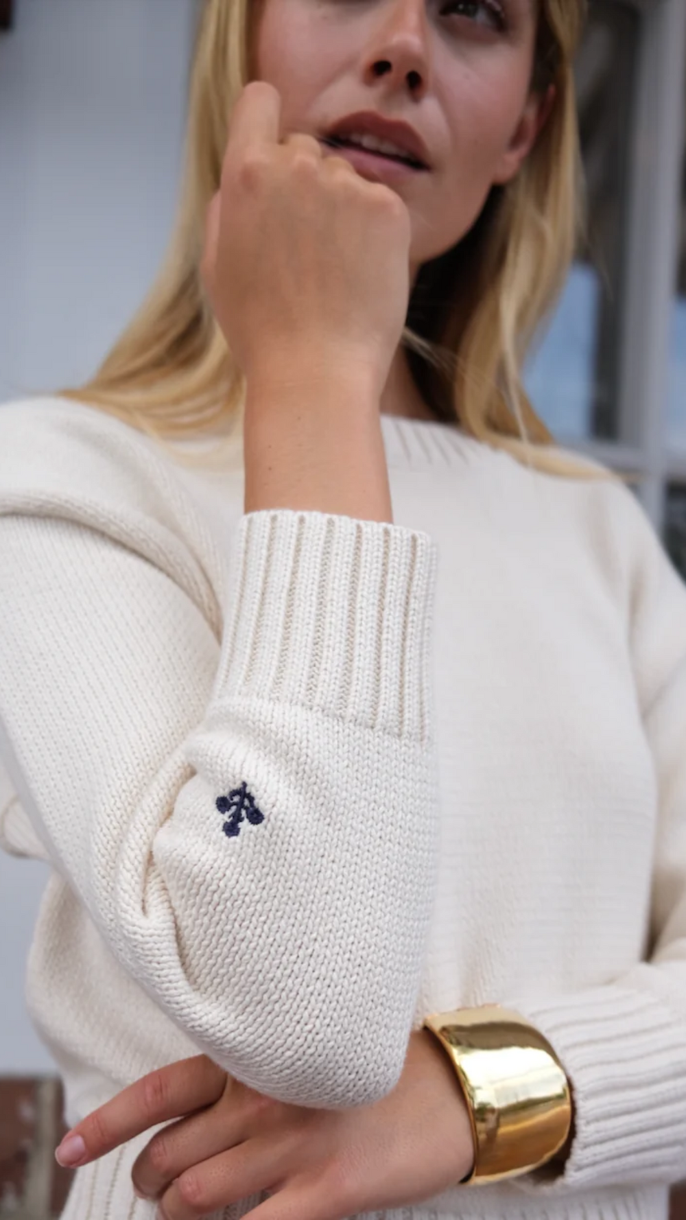 Intricate floral detail on the Marea Lake Sweater, highlighting the delicate knit pattern in 100% breathable cotton. A timeless touch to this versatile layering piece.