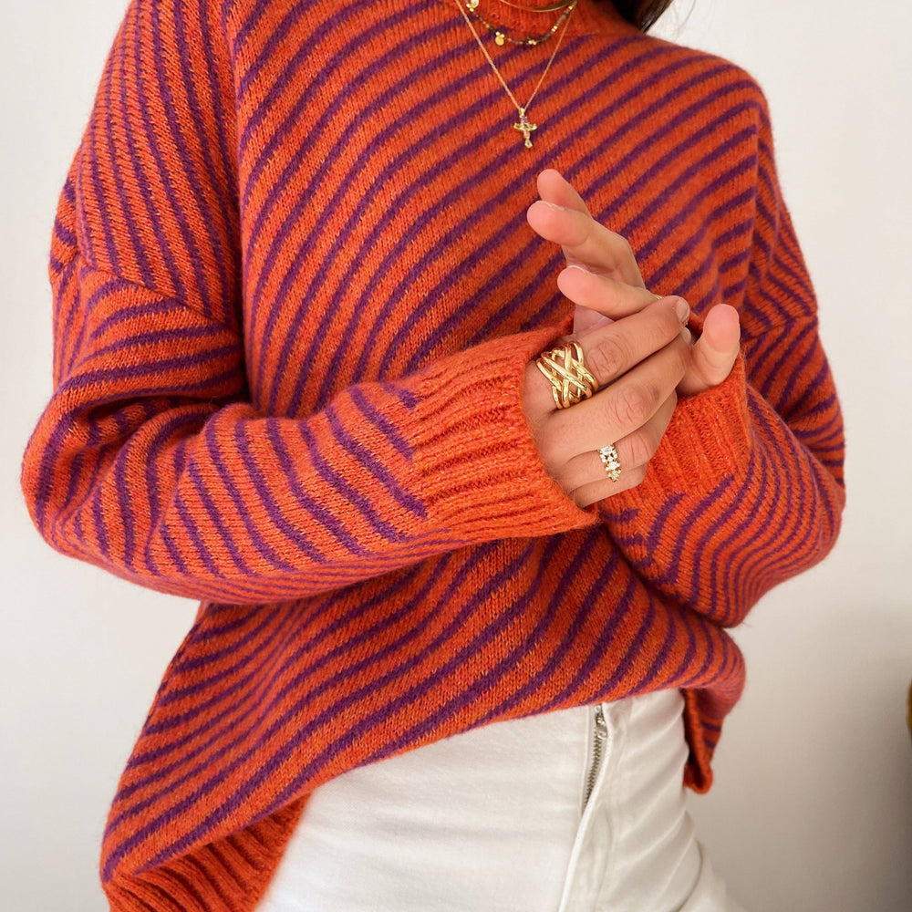 
                      
                        Long-sleeved striped sweater in shades of orange and purple, designed in Barcelona.
                      
                    