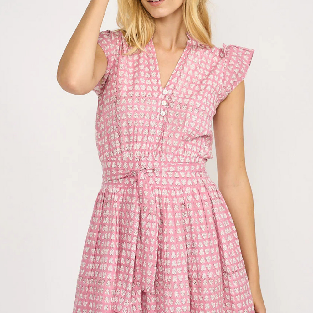 
                      
                        The Liz Dress embodies effortless style with its smocked back for a comfortable fit, practical pockets, a charming tie at the waist, and shell button details. 
                      
                    