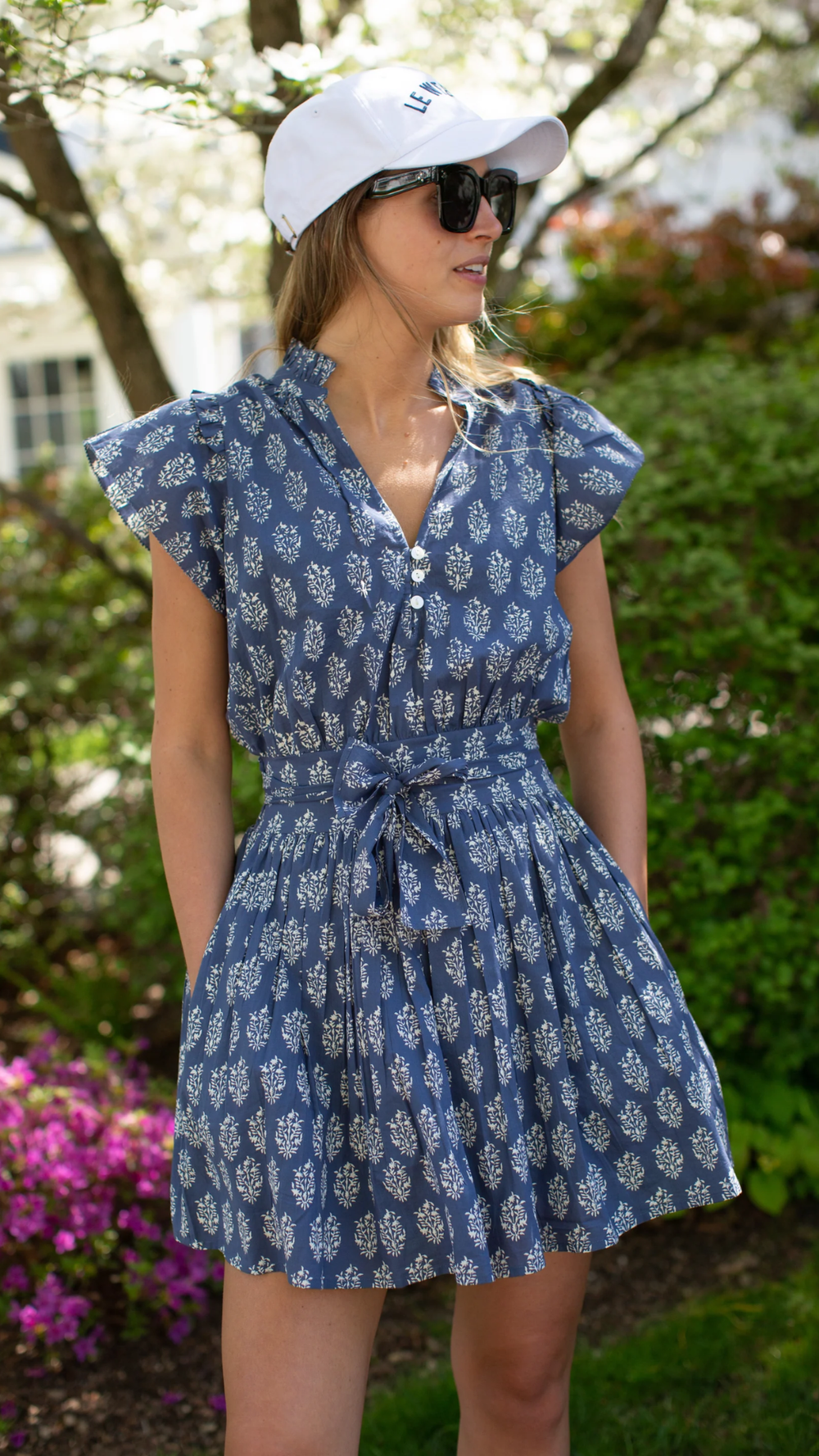 Effortlessly chic Liz dress with smocked back, pockets, tie, and shell button details, perfect for any summer occasion