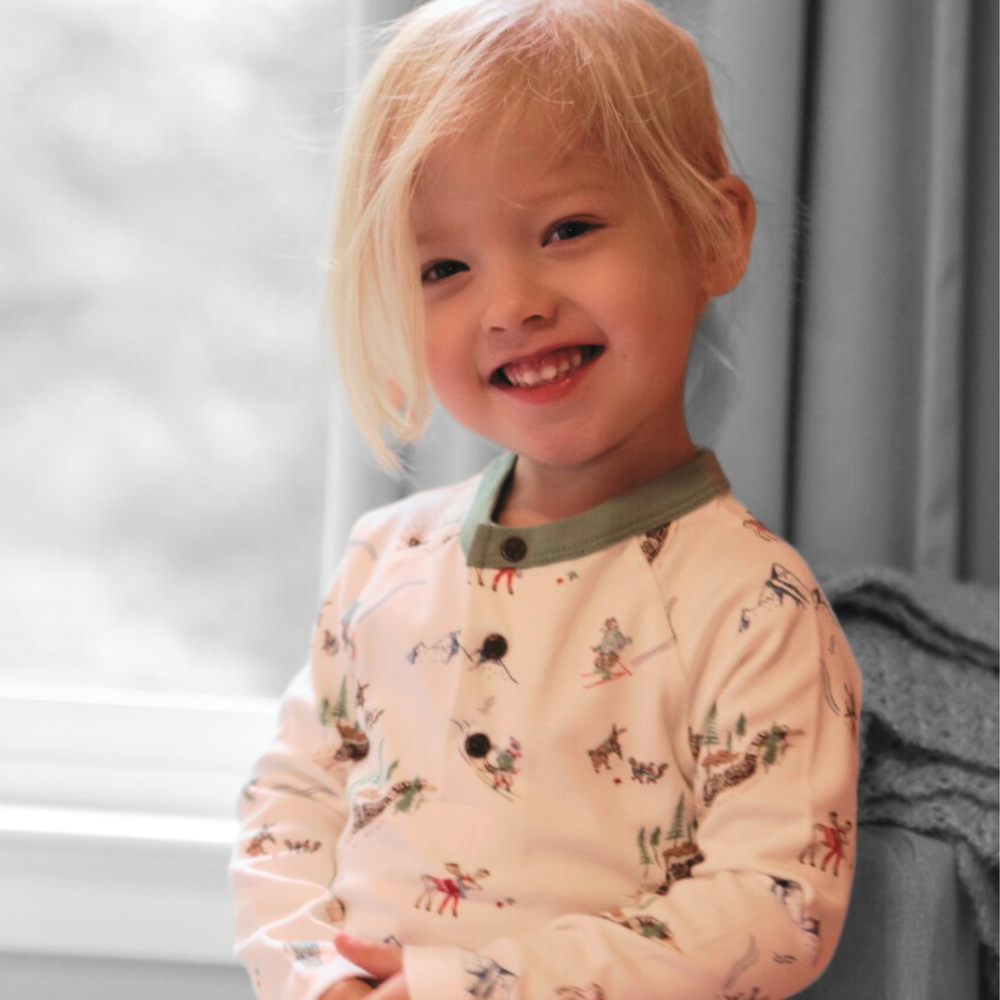 Toddler wearing the Mountain Express Long Sleeve Henley Shirt made from 100% organic cotton.