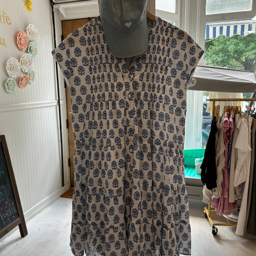 Mackenzie Dress by Marea in Atlantic Bordeaux hanging with our "Love Her But Leave Her Wild" denim heart hat in store, featuring a relaxed fit, functional buttons, and fully lined lightweight fabric, perfect for spring outings and casual weekends.