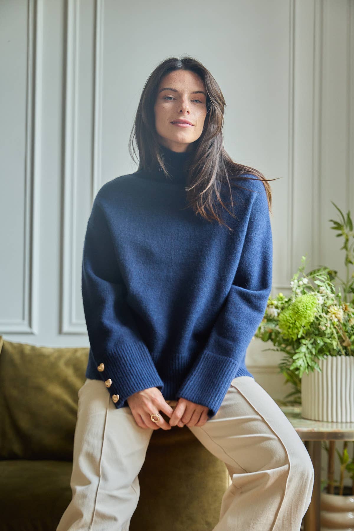 Magnolia Sweater with ribbed turtleneck and gold heart-shaped buttons on the cuffs.