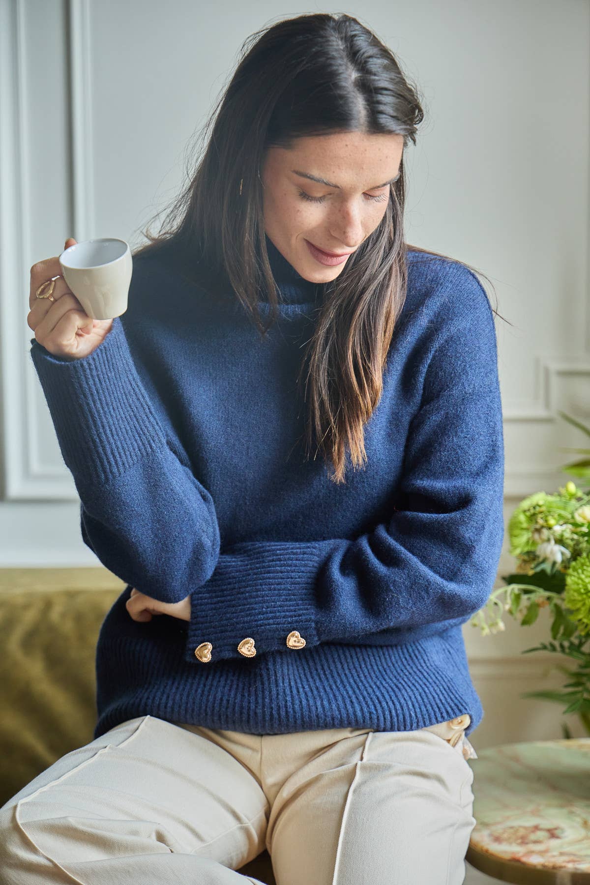 Women’s cozy Magnolia Sweater made from wool blend fabric, featuring gold heart buttons on the cuffs.