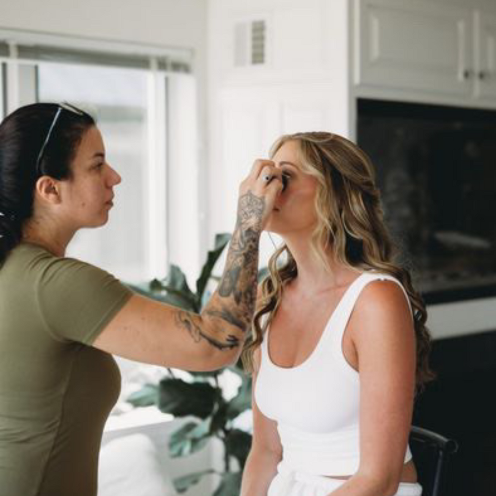 
                      
                        Nadia applying makeup on one of her brides at a makeup demo and workshop, showcasing expert bridal makeup techniques.
                      
                    