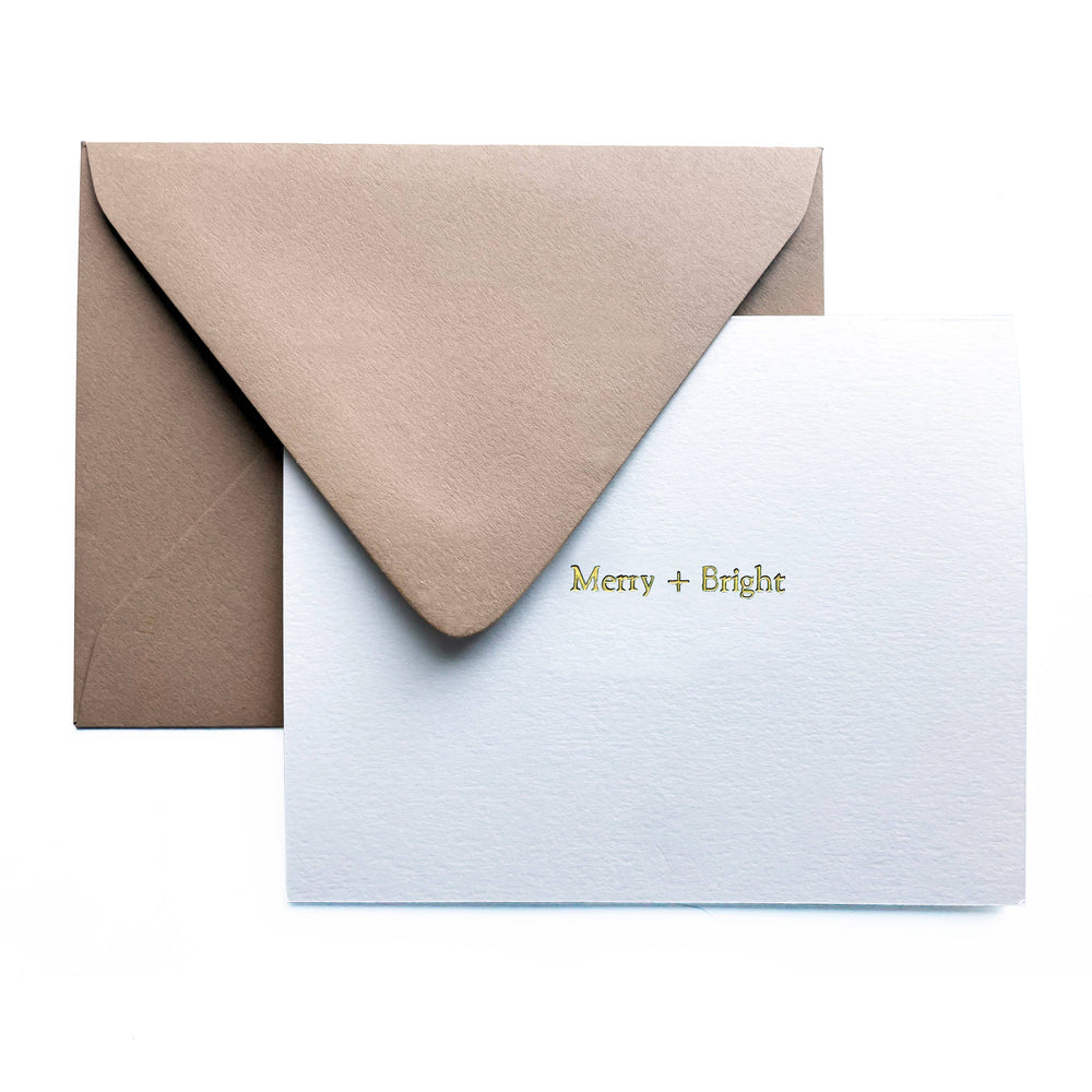 This timeless, heavyweight A2 ivory card is elegantly adorned with the joyful "Merry + Bright" message, beautifully foil-pressed in of shimmering gold.