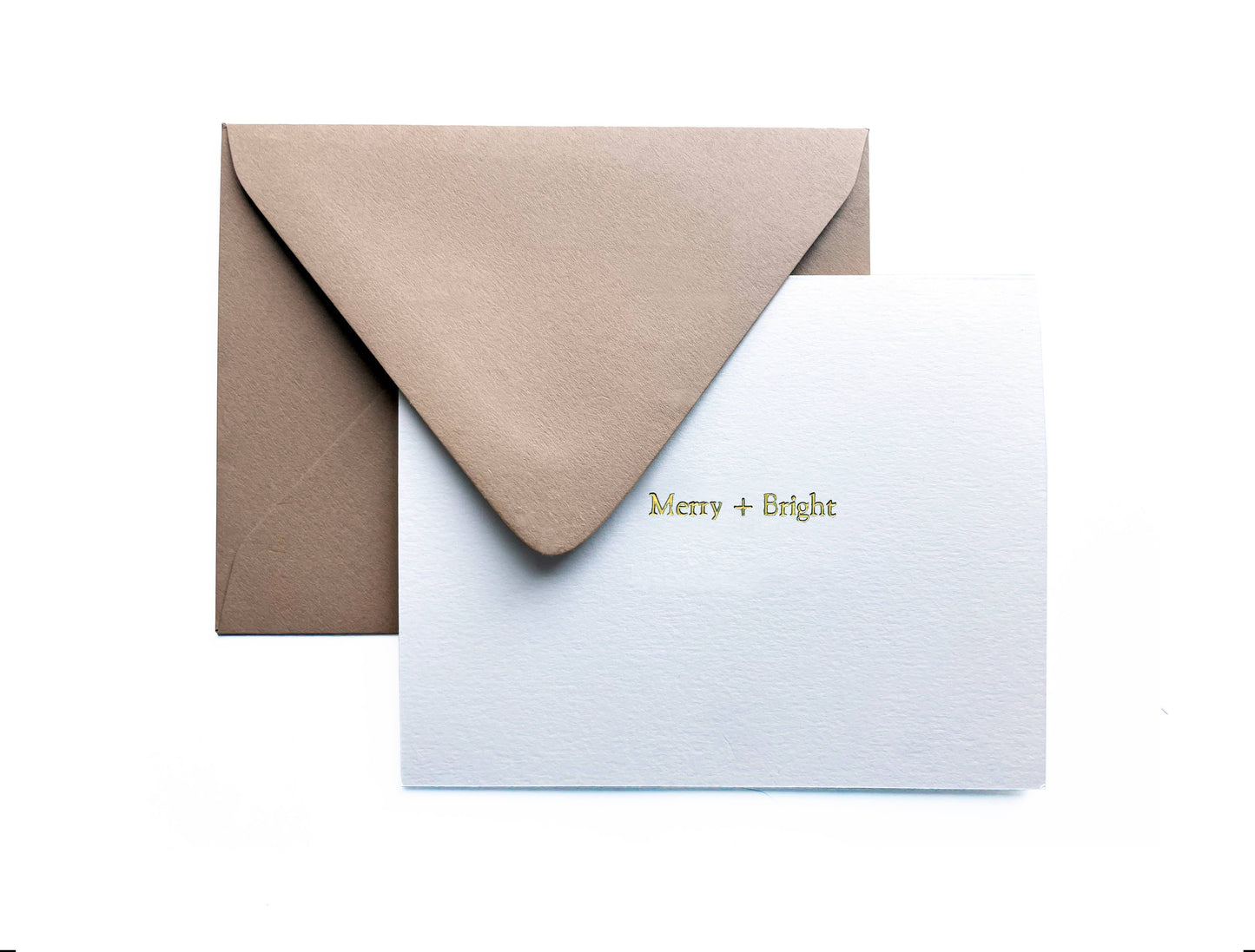 This timeless, heavyweight A2 ivory card is elegantly adorned with the joyful "Merry + Bright" message, beautifully foil-pressed in of shimmering gold.