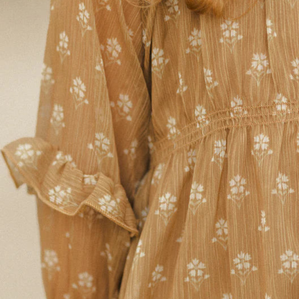 
                      
                        Close-up of ruffle detailing and cinched waist on the Mirabelle Dress
                      
                    