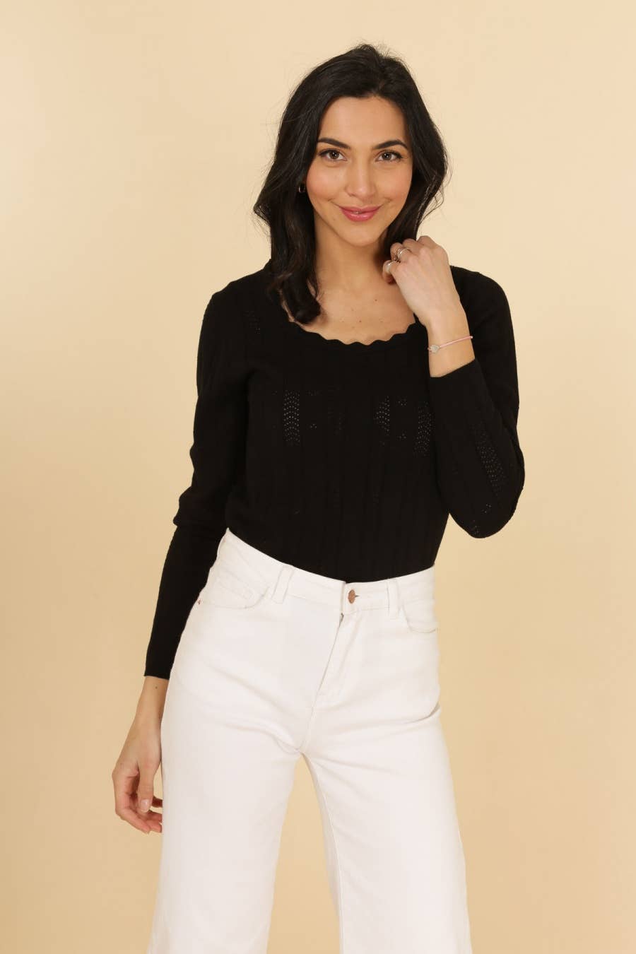 Chic black cotton knit top with elegant scalloped neckline and openwork detailing, perfect for layering.