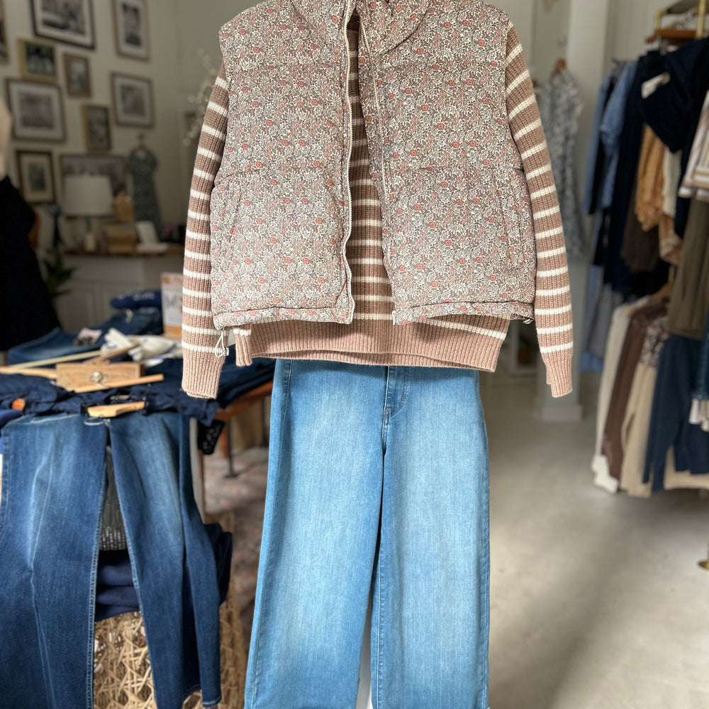 Two in one fall jeans from Morrison denim shown with their wide cuff & paired with the Marea Sweater and our floral puff vest hanging in store in Essex, CT