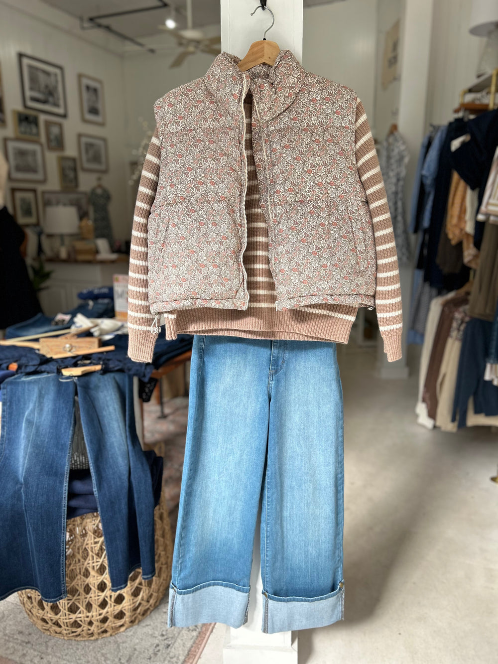 Two in one fall jeans from Morrison denim shown with their wide cuff & paired with the Marea Sweater and our floral puff vest hanging in store in Essex, CT