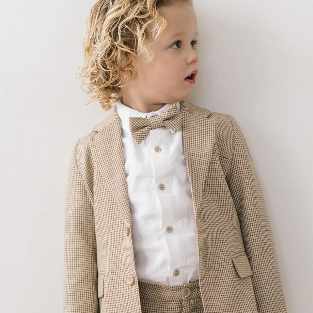 Curly haired boy wearing Houndstooth suit. 