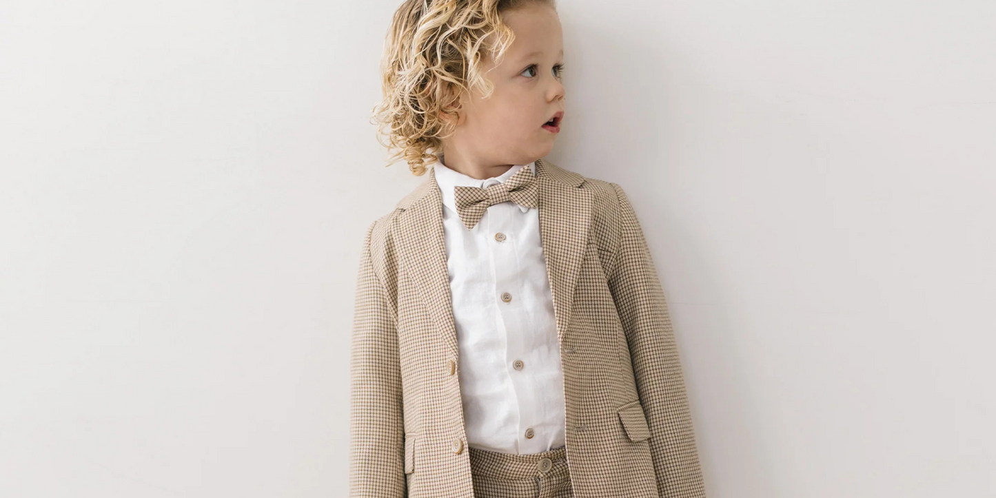 Curly haired boy wearing Houndstooth suit. 