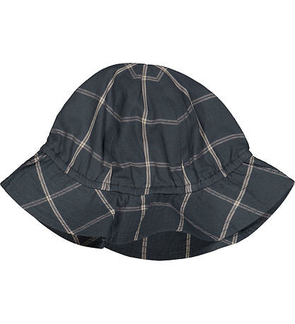 Flatlay of a baby/kids summer hat in organic cotton check pattern, featuring a wide brim and elastic interior, designed for breathable comfort and sun protection on warm days.