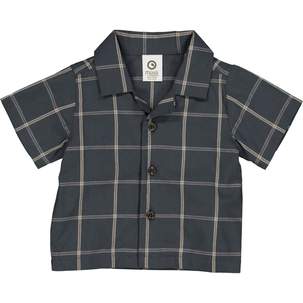 Flatlay of a baby short sleeve check shirt made from 100% organic cotton, featuring a classic collar and button-front closure, displayed on a neutral background. Ideal for layering under sweaters or vests for fall outfits.