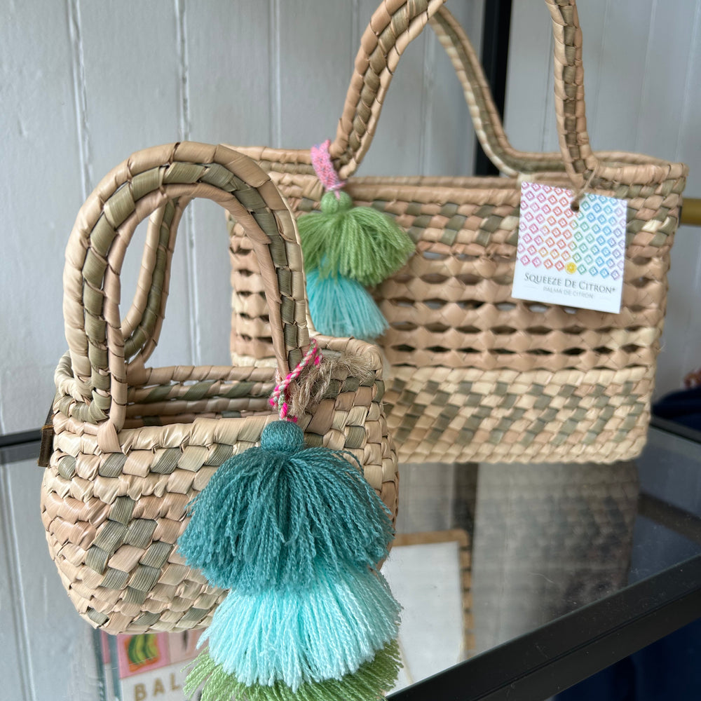 Flatlay-style shot of the Palm Net Yatzil Mini Tote in Sage on the shelf, emphasizing its compact design, optional crossbody strap, and artisanal fair trade quality.