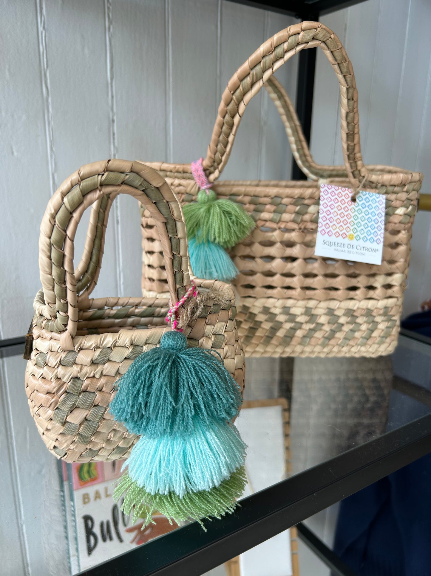Flatlay-style shot of the Palm Net Yatzil Mini Tote in Sage on the shelf, emphasizing its compact design, optional crossbody strap, and artisanal fair trade quality.