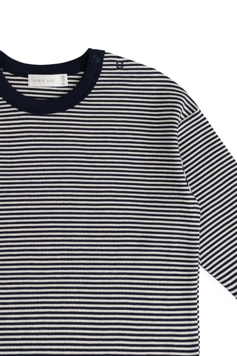 A close-up of a striped long-sleeve top with thin horizontal navy and white stripes, featuring a solid navy crew neck collar. The brand label 'JAMIE KAY' is visible inside the collar.