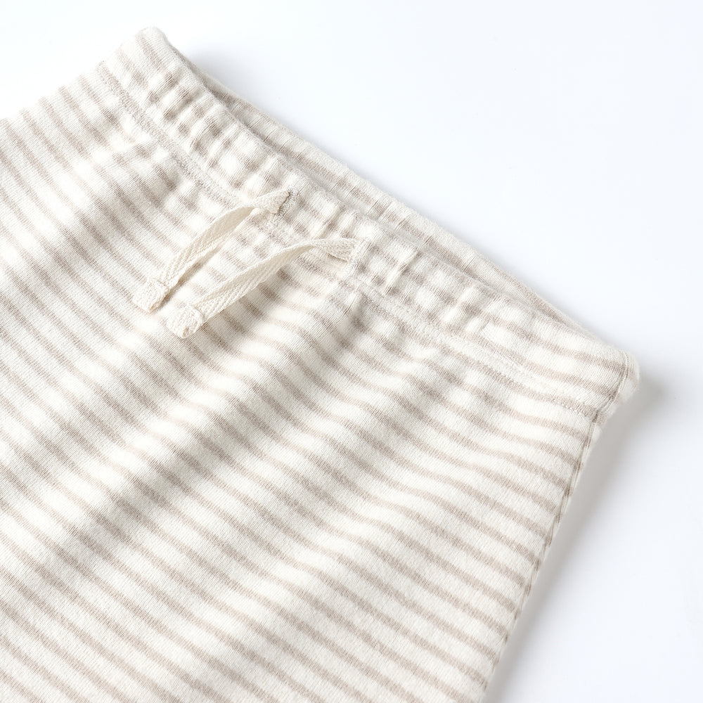 
                      
                        Close-up of Quincy Mae Drawstring Pant showing soft organic cotton knit, oat micro stripe pattern, and functional drawstring detail.
                      
                    