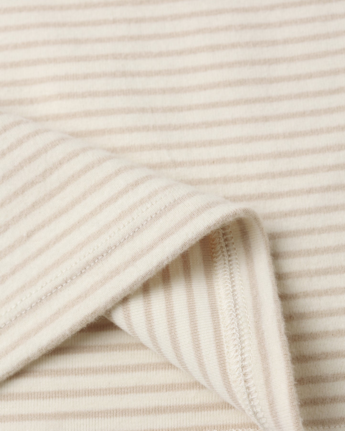 Close-up of Quincy Mae Long Sleeve Tee showing soft organic cotton fabric and oat micro stripe texture.