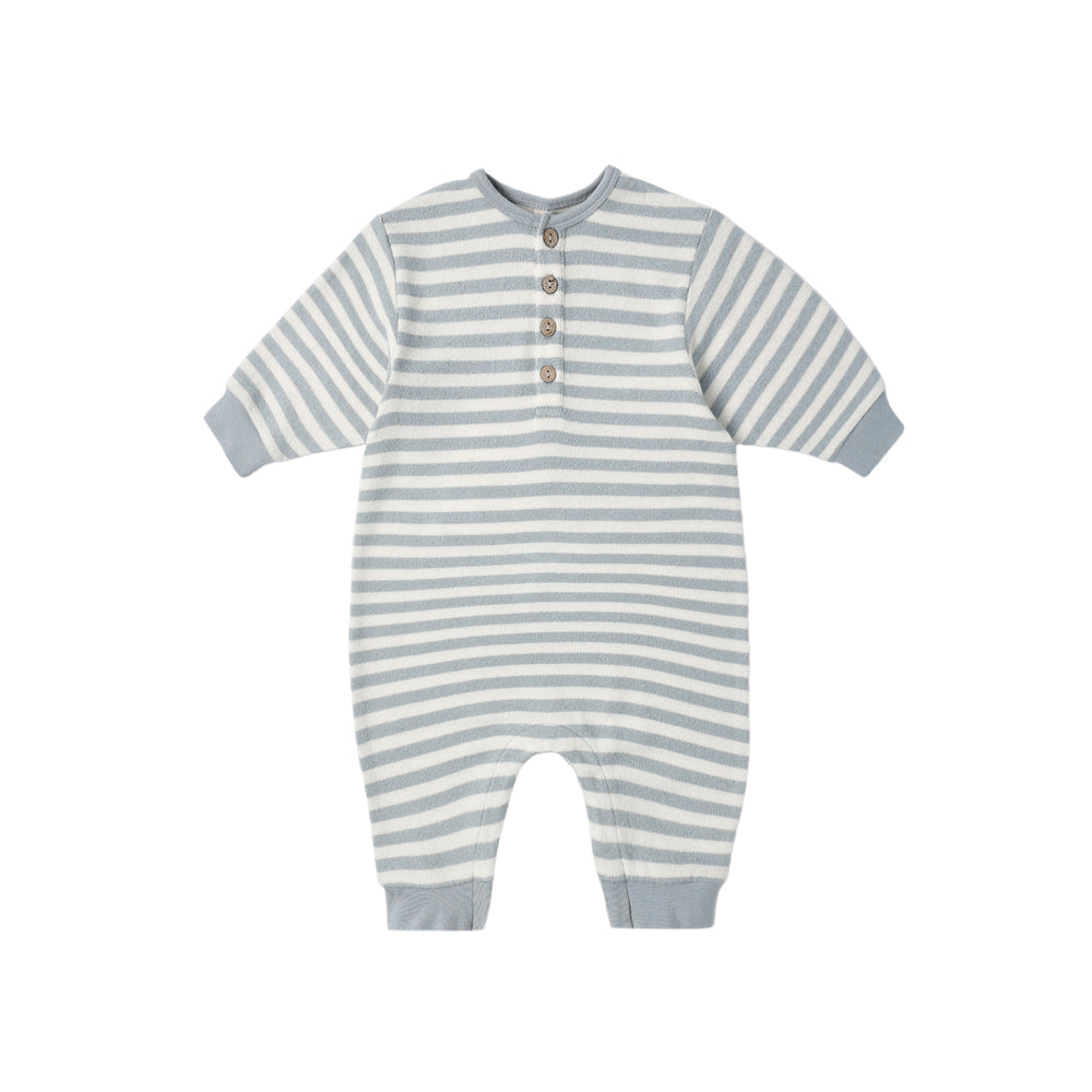 Flatlay of Quincy Mae Relaxed Jumpsuit in Blue Stripe with coconut buttons.