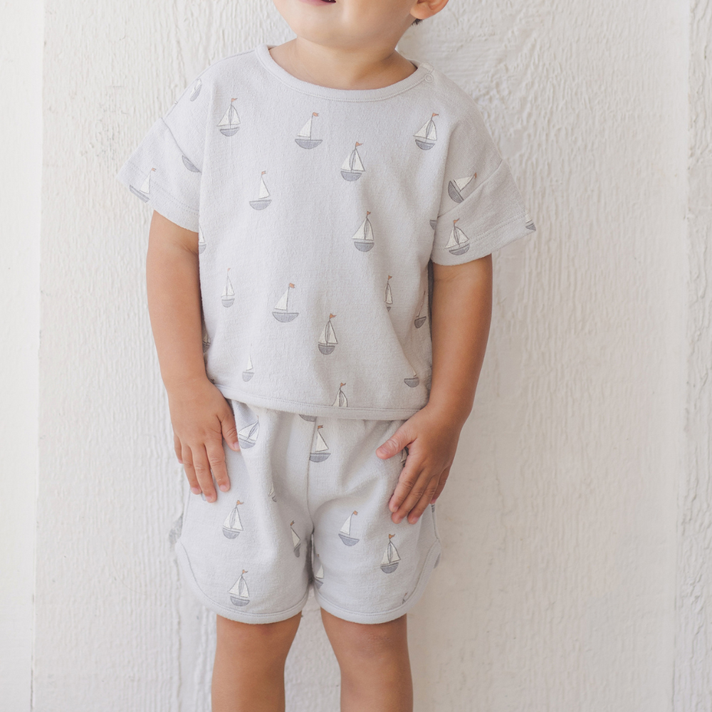 
                      
                        A full-body image of a toddler boy dressed in the matching Quincy Mae Spongy Play Set, featuring a breathable cotton-blend fabric and elastic waistband for all-day play.
                      
                    