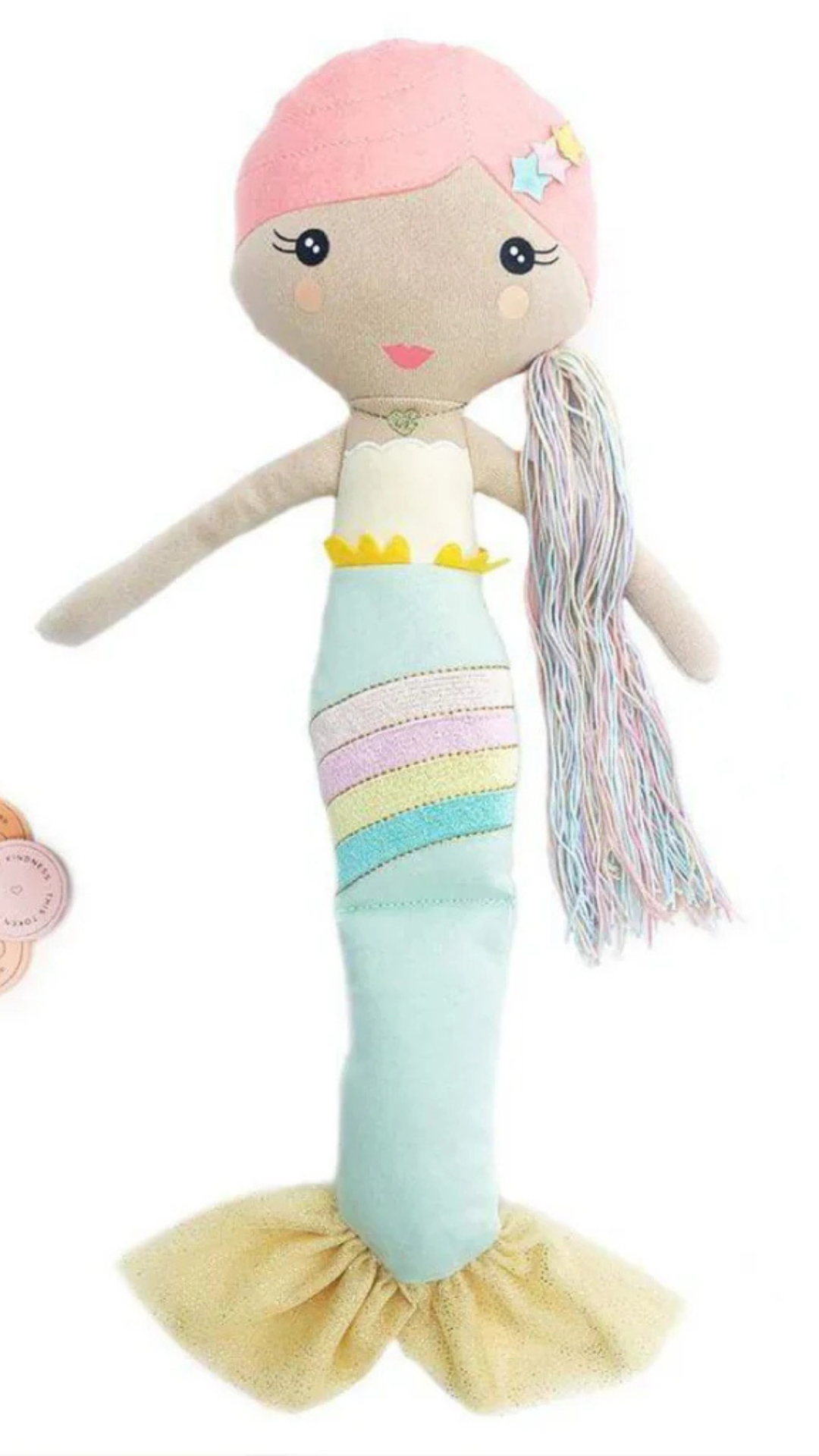 A captivating top-down view of the Shine Mermaid Kindness Doll accompanied by kindness tokens, ready to encourage kids to spread kindness with each act.