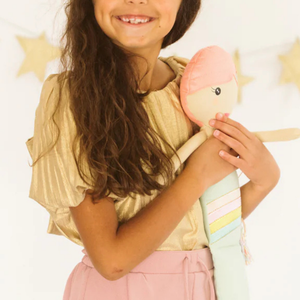 
                      
                        Joyful little one hugging her Shine Mermaid Kindness Doll, capturing the love and affection the doll inspires in children while teaching kindness.
                      
                    